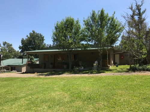 a house with a yard in front of it at The Retreat Country Lodge in Romelcoh