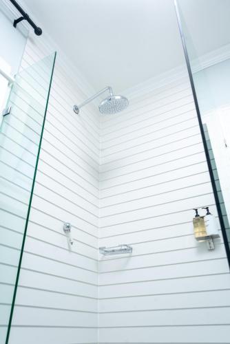 a bathroom with a shower with a glass door at 53A Luxury Bed & Breakfast in Gaborone
