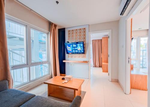 a living room with a couch and a table at Astara Hotel Balikpapan in Balikpapan