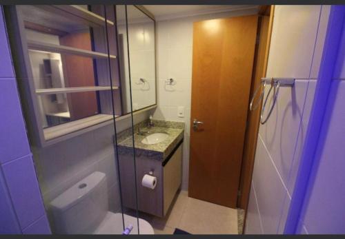 a bathroom with a toilet and a sink and a mirror at Luxor Paulo Miranda Frente ao mar in João Pessoa