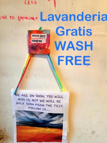 a sign on a wall with a rainbow at La casa dell’artista di Vittorio Vertone in Pietragalla