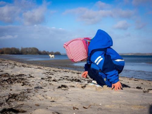 a person playing in the sand on a beach at Ferienwohnung GlüXX in Ulstrupfeld