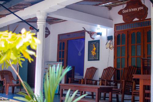 a room with chairs and a table and a door at Tourist Holiday Inn in Dambulla