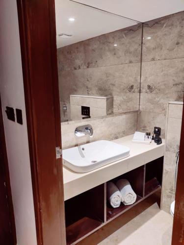 a bathroom with a sink and a mirror at Heena Heritage Resort in Jaipur