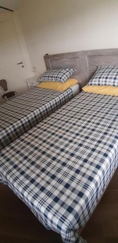 two beds sitting next to each other in a room at CASCINA BINELLO appartamenti A & B in Belvedere Langhe