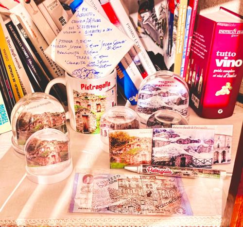 a table with two glass domes and books on it at La casa dell’artista di Vittorio Vertone in Pietragalla