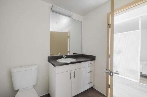 a bathroom with a white toilet and a sink at Blueground Columbia City gym wd nr parks SEA-786 in Seattle
