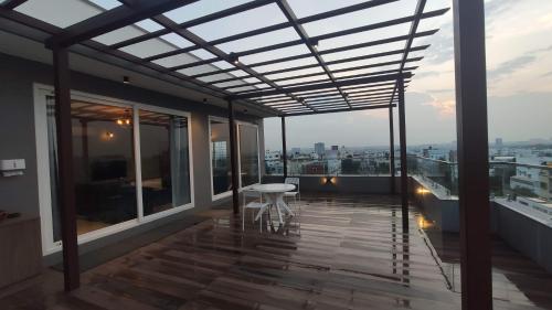 a balcony with a table and a view of the city at Trinetra Homes 61 in Bengaluru