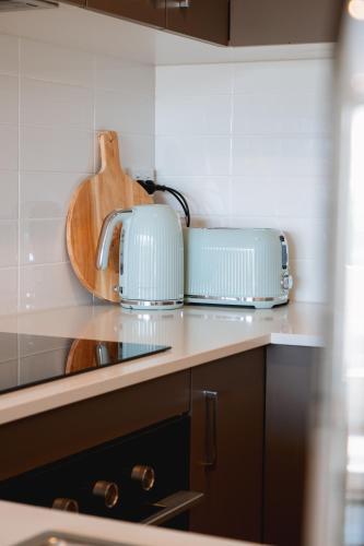 a kitchen with two toasters on a counter at Ocean Verge Apartments in Caloundra