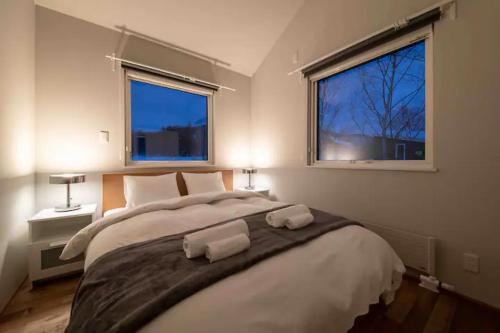 Postel nebo postele na pokoji v ubytování Momo Niseko