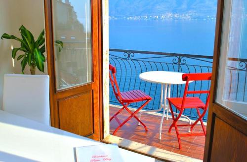 a balcony with a table and two chairs and a table at Belvedere - Apartment with Balcony Lake View in Sala Comacina
