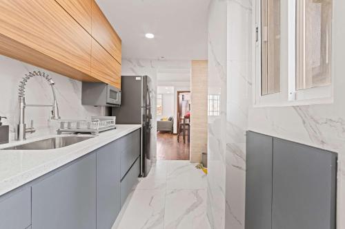 a kitchen with a sink and a refrigerator at Spacious Apartment with 2 Bedrooms in CDMX in Mexico City