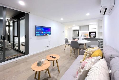 a living room with a couch and a table at Pride Moonee Ponds 1B2B Nest in Melbourne