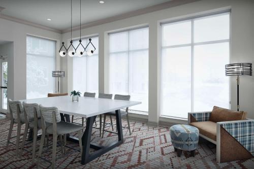 a dining room with a white table and chairs at Hilton Garden Inn Casper in Casper