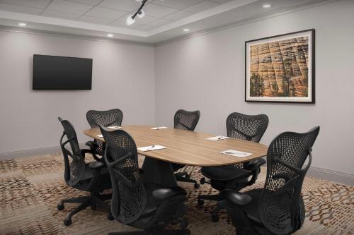 a conference room with a wooden table and chairs at Hilton Garden Inn Casper in Casper
