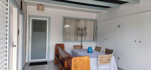a dining room with a blue table and chairs at Broken Hill Outback Church Stay in Broken Hill