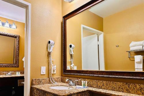 a bathroom with a sink and a mirror at Quality Inn & Suites Westminster Seal Beach in Westminster