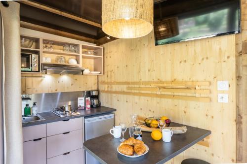 a kitchen with a table with bread and fruit on it at CityKamp Valkenburg - Maastricht in Valkenburg