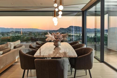 a dining room with a table and chairs at Althea Lavish Estate - Villa & Suite in Zakynthos Town