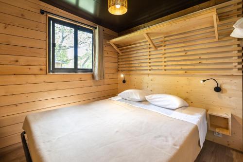 a bedroom with a bed in a wooden room at CityKamp Valkenburg - Maastricht in Valkenburg