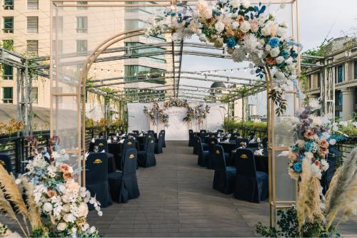 a wedding ceremony in a greenhouse with chairs and flowers at Thang Long Opera Hotel in Hanoi
