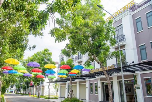 a group of colorful umbrellas hanging from a building at The Vista Châu Đốc Hotel in Chau Doc