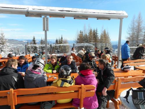 a group of people sitting at tables on a ski lift at Villa Relax am See in Bodensdorf