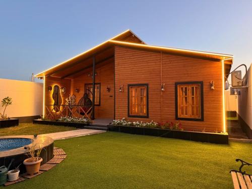 a small house with a lawn in front of it at كوخ سترين in Tabuk