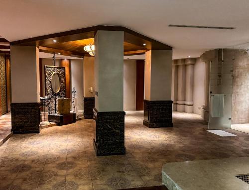 a lobby with columns and a mirror on the wall at All-Ur Boutique Motel - Taichung Branch in Taichung