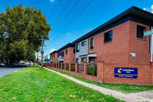 a brick building with a sign on the side of it at Comfort Inn Serenity Bathurst in Bathurst