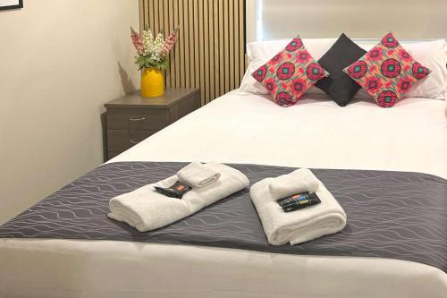 a bed with two towels on top of it at Comfort Inn Serenity Bathurst in Bathurst