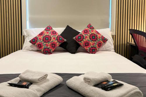 a bed with two towels and pillows on it at Comfort Inn Serenity Bathurst in Bathurst