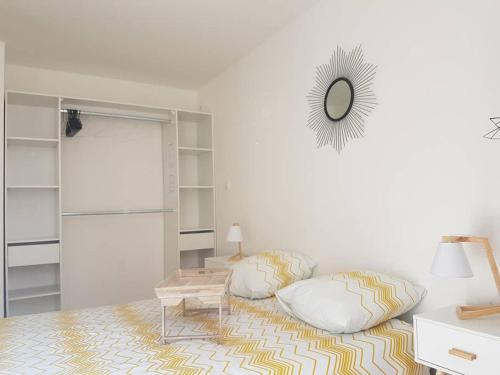 a living room with a couch and a mirror at COCON du centre ville avec PARKING et WIFI in Millau
