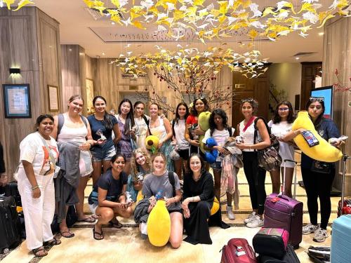 a group of people posing for a picture with luggage at Thang Long Opera Hotel in Hanoi