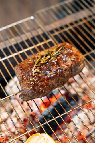 a piece of meat sitting on top of a grill at Palm Villa in Nha Trang
