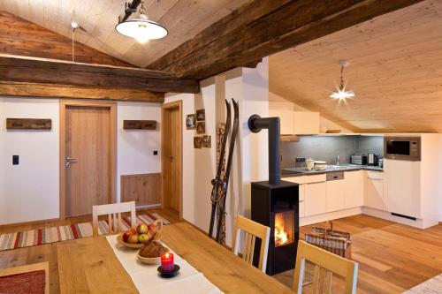 a kitchen and dining room with a wood stove at Appartements Innerthal in Inneralpbach