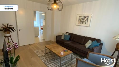 a living room with a couch and a table at H1 with 4,5 Room, Bathroom, Kitchen, Central, quiet & modern with office in Zürich