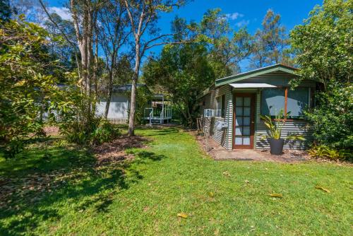 a small house with a yard at Lumeah by the Creek in Whian Whian