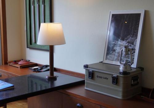 a lamp sitting on a desk next to a picture at Mandarin Oriental, Sanya in Sanya