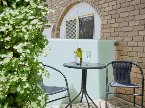 a table and two chairs on a patio at Arlingtons Holiday Accommodation in Portarlington