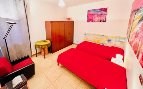 a living room with a red couch and a table at La casa dell’artista di Vittorio Vertone in Pietragalla