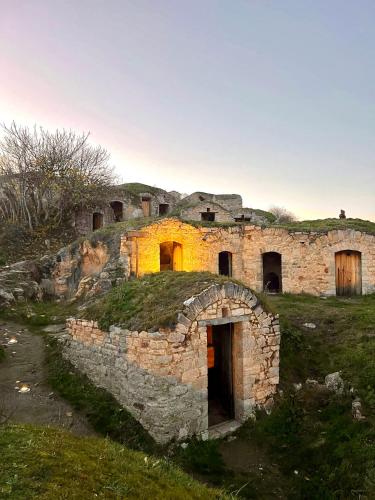 an old stone building on top of a hill at La casa dell’artista di Vittorio Vertone in Pietragalla