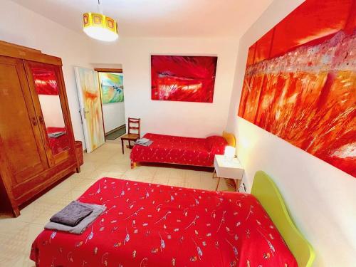 a bedroom with a red bed and a red couch at La casa dell’artista di Vittorio Vertone in Pietragalla