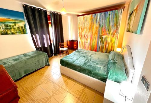 a bedroom with a bed and a large window at La casa dell’artista di Vittorio Vertone in Pietragalla