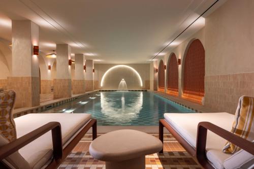 a swimming pool with a fountain in a hotel room at Hotel Grand Coeur Latin in Paris