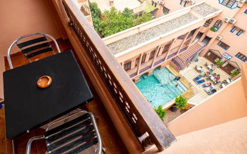 an overhead view of a swimming pool from a balcony at Hotel Oudaya & Spa in Marrakech