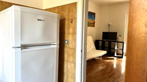 a white refrigerator in a room with a living room at N194 - Numana, ampio trilocale con giardino in Numana