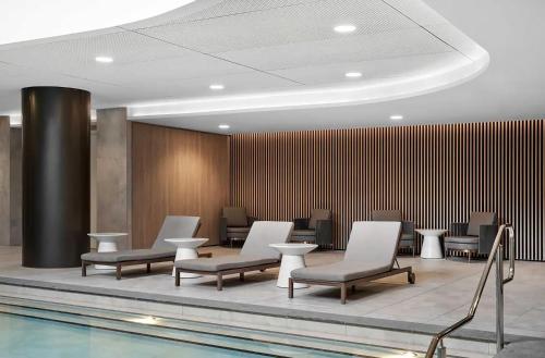a hotel lobby with chairs and a swimming pool at Heart of Glen Waverley Pool Gym Parking in Glen Waverley