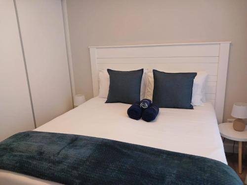 a bed with two blue bows on top of it at 106 Mossel Cove in Mossel Bay