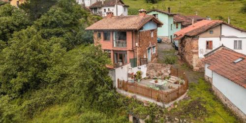 an aerial view of a house on a hill at Carbayu Senda del Oso in Proaza